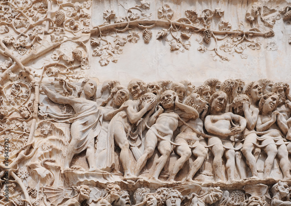 Bas-relief picturing hell, detail on the exterior gable of the cathedral in Orvieto (duomo di Orvieto, cattedrale di Santa Maria Assunta), one of the most beautiful churches in Italy