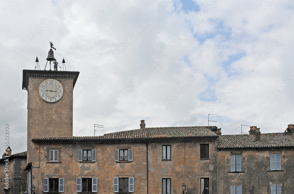 Fourteenth century Maurizio Bell Tower on the Piazza Duomo in Orvieto, Italy, with white clouds on a spring day