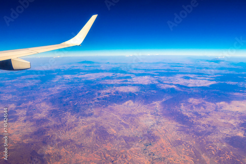 Flying airplane over Mexico Clouds Sky Volcanoes Mountains City desert.