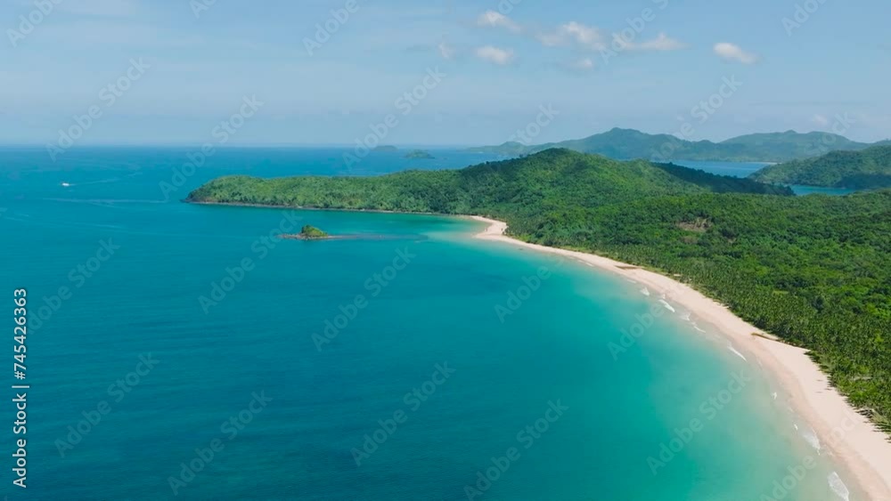 Stunning view of Nacpan Beach with cream-coloured sand and coconut trees. El Nido, Palawan. Philippines. Stunning view of Nacpan Beach with cream-coloured sand and coconut trees. El Nido, Palawan. Philippines.