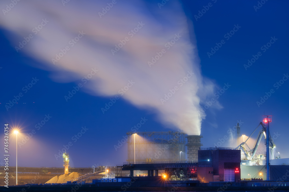Heavy industry. View of production and factory. Panoramic view of the factory at night. Emission of harmful substances into the atmosphere. Photo for background, advertising and wallpaper. Heavy industry. View of production and factory. Panoramic view of the factory at night. Emission of harmful substances into the atmosphere. Photo for background, advertising and wallpaper.