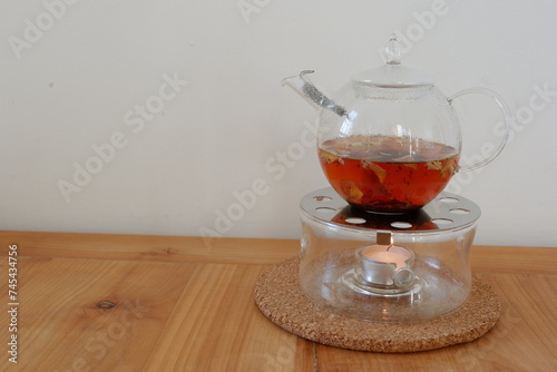 A glass tea pot with black tea