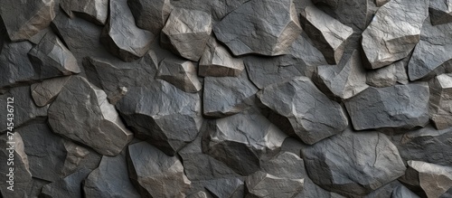 A black and white image showcasing a seamless texture of a grey concrete stone background, featuring a rugged rock wall.