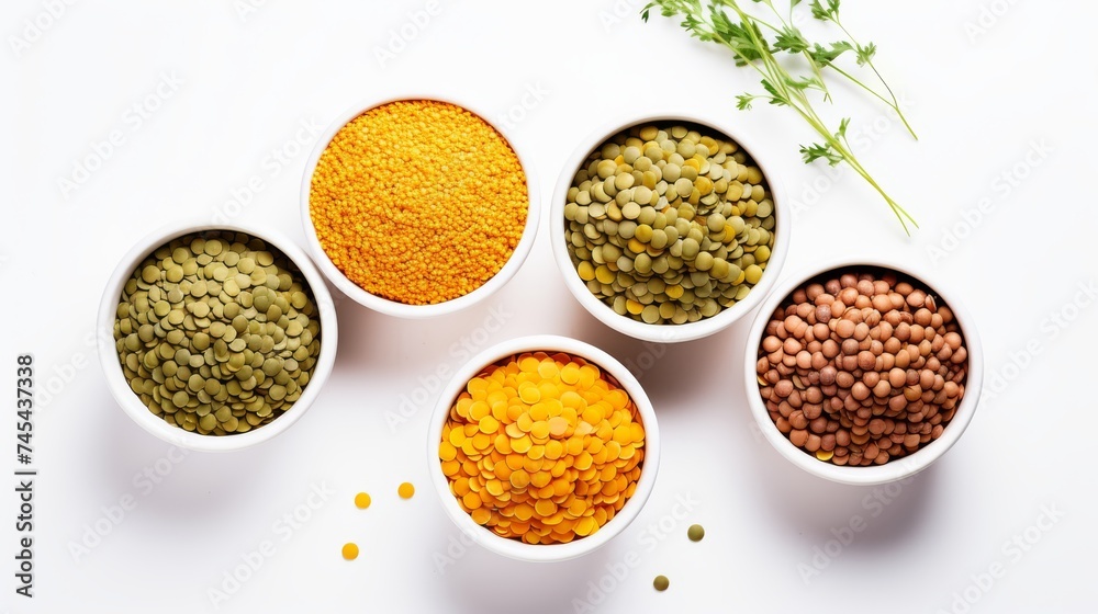 Assorted legumes and grains in bowls on white background. Top view. Concept of vegetarian protein sources, healthy eating, and dietary diversity.