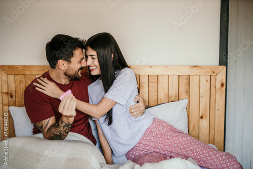 Smiling couple sharing a special moment with a positive pregnancy test. copy space