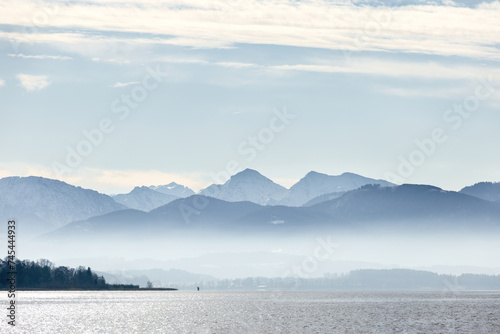 View at lake chiemsee, bavaria, germany, in late winter, february. Chiemgau alps are seen in the background photo
