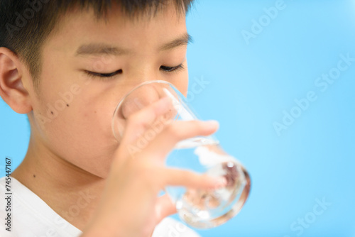 Young Asian boy drink water