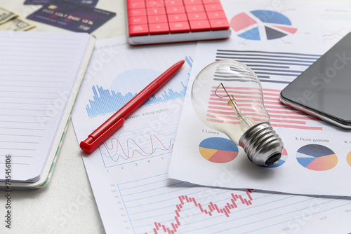Light bulb, pen and charts ...