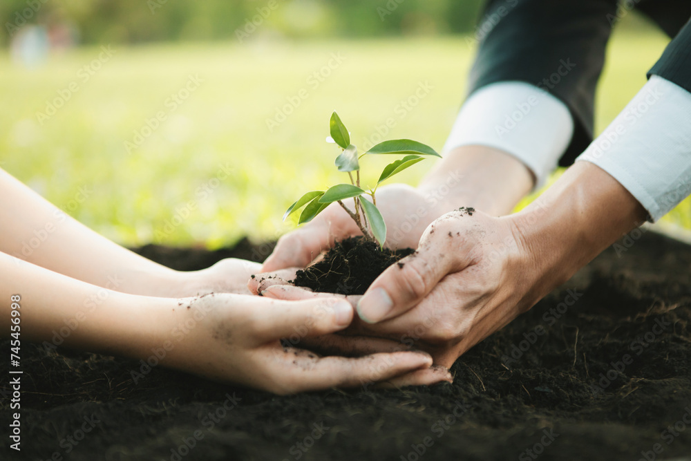 Φωτογραφία Businessman grow and nurture plant on fertilized soil with young boy as eco company committed to corporate social responsible, reduce CO2 emission and embrace ESG principle for sustainable future