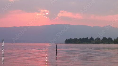 Sunset over Ochrid lake water. photo