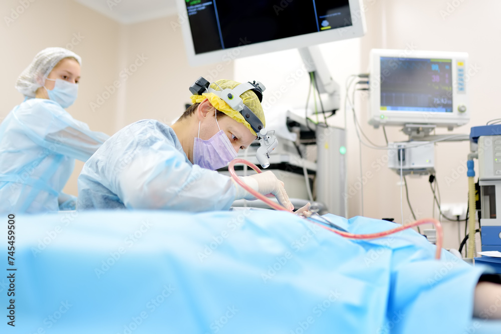 Surgeons are during maxillofacial operation in modern hospital. Teamwork of doctors. Maxillofacial surgery. Surgeons are during maxillofacial operation in modern hospital. Teamwork of doctors. Maxillofacial surgery.
