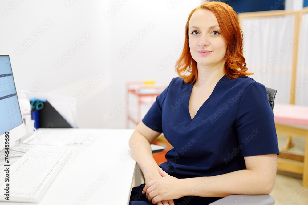 Portrait of a smiling female neurologist looking at camera in the office of a modern clinic. The neurology doctor is at work. Portrait of a smiling female neurologist looking at camera in the office of a modern clinic. The neurology doctor is at work.