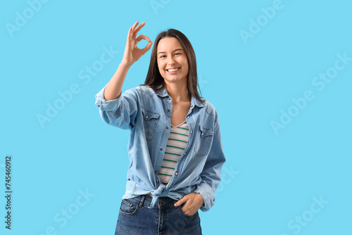 Young woman showing OK on b...