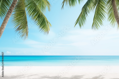 Palm trees on sandy beach with the azure ocean in the background, under a bright blue sky with fluffy clouds on a tropical daytime natural landscape