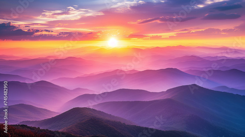 Breathtaking sunrise over layered mountain landscape with vibrant colors, ideal for backgrounds with ample copy space © fotogurmespb