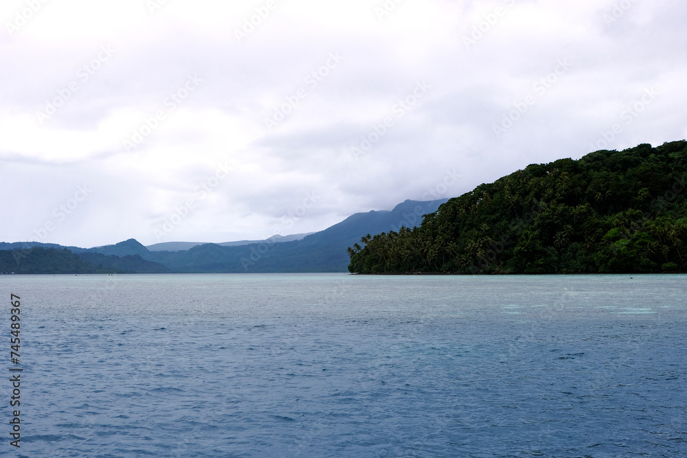 Scenic ocean view with remote tropical island covered in jungle rainforest in Pohnpei, Federated States of Micronesia