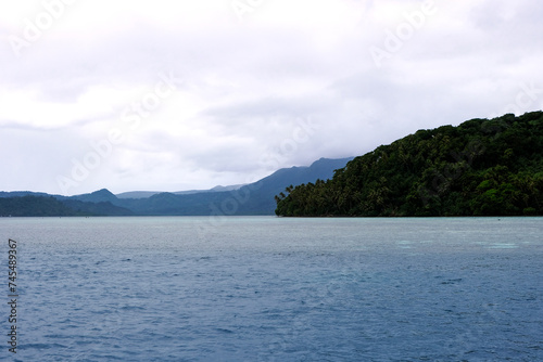 Scenic ocean view with remote tropical island covered in jungle rainforest in Pohnpei, Federated States of Micronesia