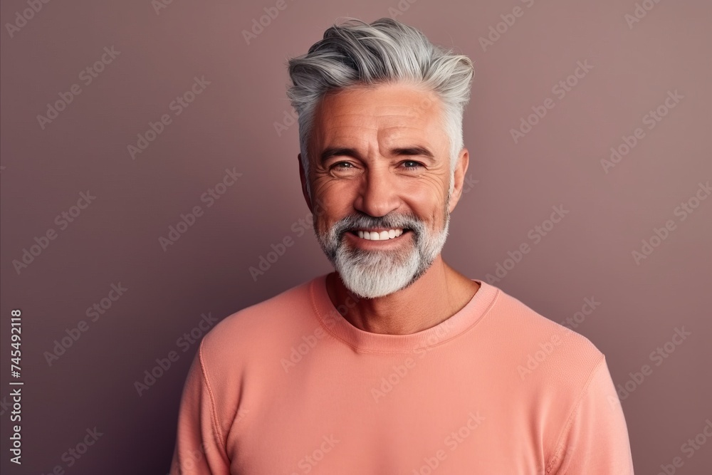 Portrait of a handsome mature man with grey hair and beard. Portrait of a handsome mature man with grey hair and beard.