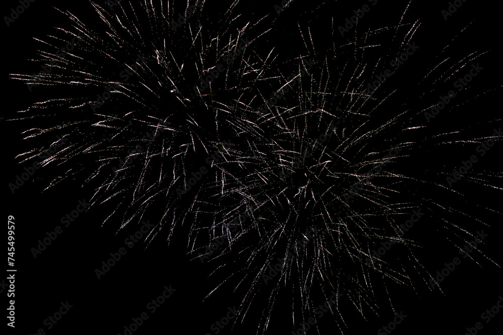 Fireworks in the night sky. Fireworks against a black sky. Sparks from a fireworks explosion on a black sky.