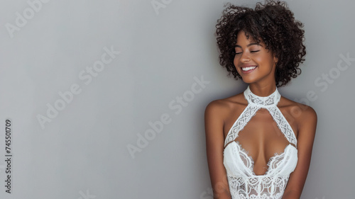 Afro woman wearing white halter neck dress smile, isolated on gray