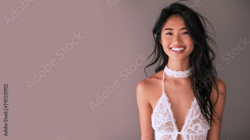Malay woman wearing white halter neck dress smile, isolated on gray