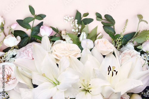 Delicate blooming festive white lilies (lilium flowers) with summer flowers, blossoming bright rose flower background, bouquet floral card, selective focus, shallow DOF	