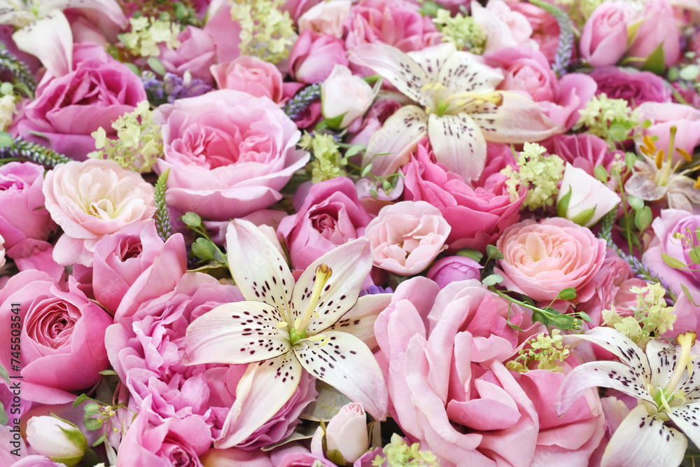 Obraz premium Delicate blooming festive light pink lilies (lilium flowers) with summer flowers, blossoming bright rose flower background, bouquet floral card, selective focus, shallow DOF
