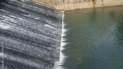 water flowing from dam into the river