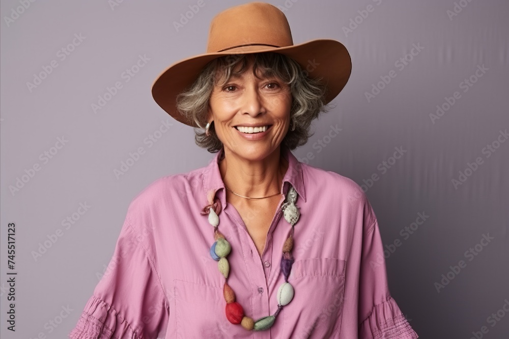 Portrait of a smiling senior woman wearing a hat and a shirt