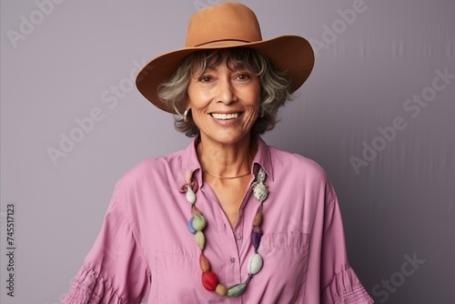Portrait of a smiling senior woman wearing a hat and a shirt
