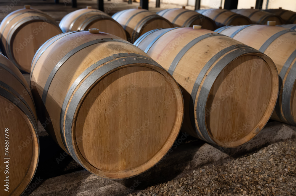 WIne celler with french oak barrels for aging of red wine made from Cabernet Sauvignon grape variety, Haut-Medoc vineyards in Bordeaux, left bank Gironde Estuary, Pauillac, France