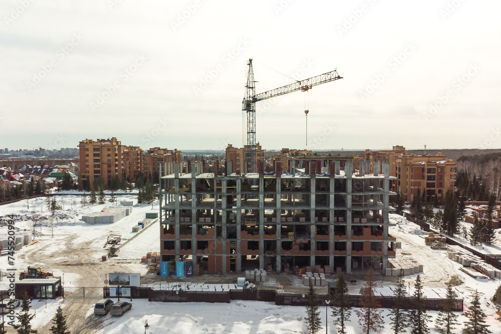 the construction site of an apartment building in the winter from a height