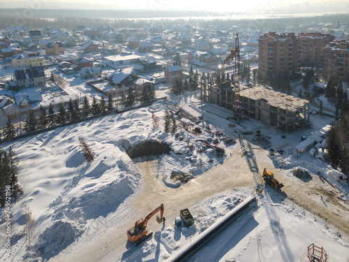 the construction site of an apartment building in the winter from a height