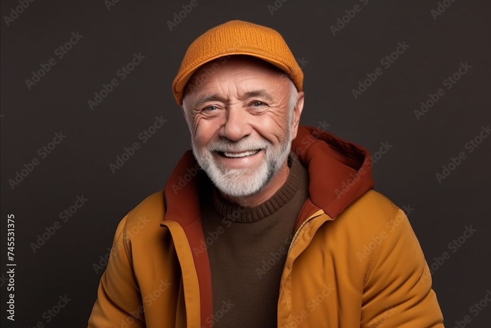 Portrait of a happy senior man in a yellow jacket and hat Portrait of a happy senior man in a yellow jacket and hat