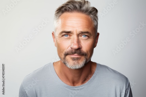 Portrait of a handsome mature man with grey hair and beard. © Iigo