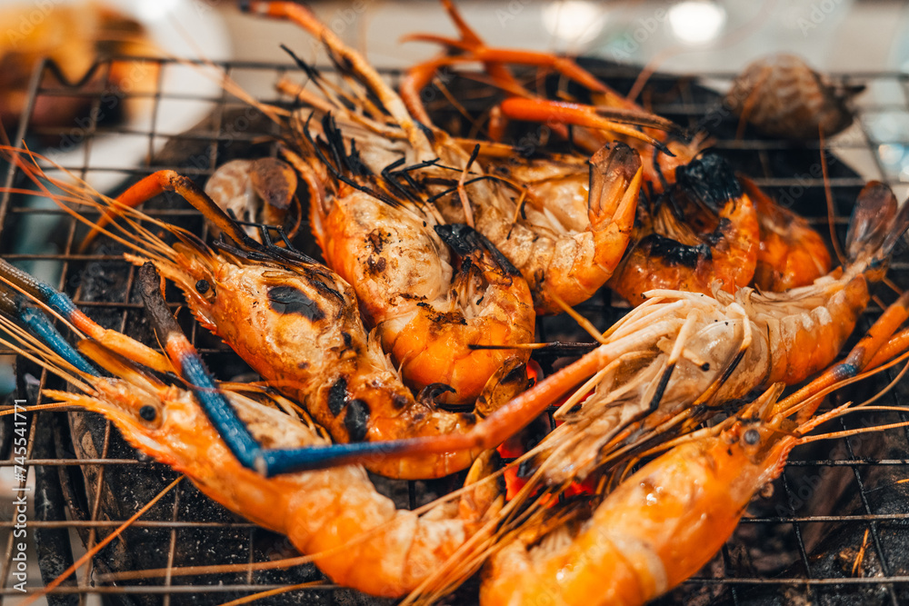 Shrimp grilled in a charcoal grill at a street food Shrimp grilled in a charcoal grill at a street food