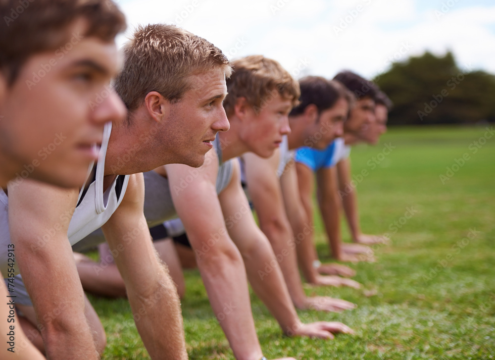 Group, men and field for push up with fitness, training and health with friends for sport, challenge or wellness. People, athlete and teamwork with exercise, workout and together on field for muscle Group, men and field for push up with fitness, training and health with friends for sport, challenge or wellness. People, athlete and teamwork with exercise, workout and together on field for muscle