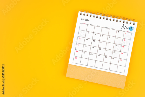 March 2024 desk calendar on yellow color background.