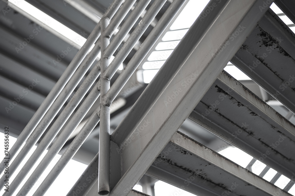 Obraz premium Metal overpass platform with banister structure of the factory place. Industrial building part. Close-up and selective focus.