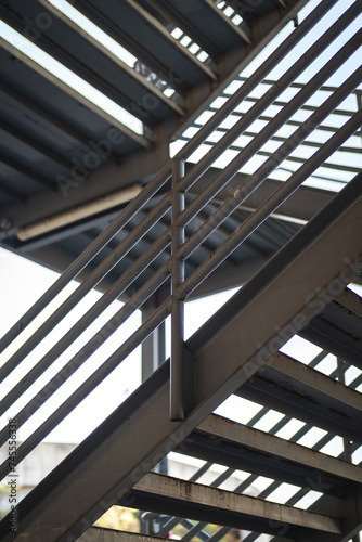 Metal overpass platform with banister structure of the factory place. Industrial building part. Close-up and selective focus. © Nattawit