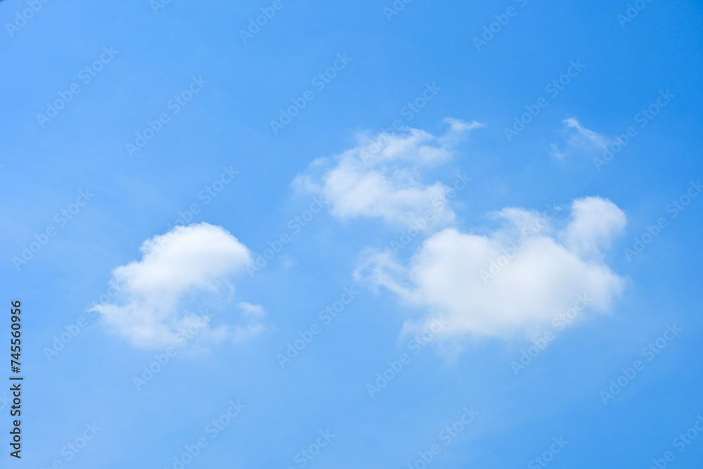 beautiful blue sky and white fluffy group of clouds with sunrise in the morning, natural background