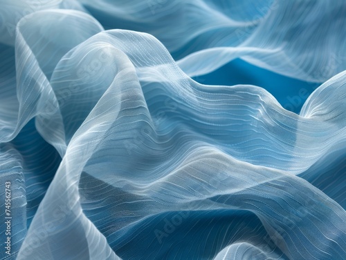 A close-up of delicate waves of sheer blue fabric creates a serene and flowing visual, reminiscent of tranquil ocean waves.