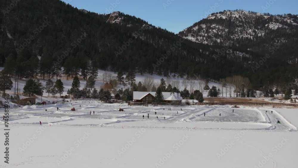 Ice skating skate hockey rink lake pond hockey winter Etown Evergreen Lake house Denver golf course Colorado aerial cinematic drone sunny bluesky morning winter fresh snow slowly pan up reveal forward Ice skating skate hockey rink lake pond hockey winter Etown Evergreen Lake house Denver golf course Colorado aerial cinematic drone sunny bluesky morning winter fresh snow slowly pan up reveal forward
