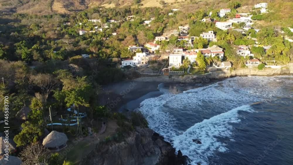 Aerial drone shot of ocean waves crashing against the shore in El Salvador Aerial drone shot of ocean waves crashing against the shore in El Salvador