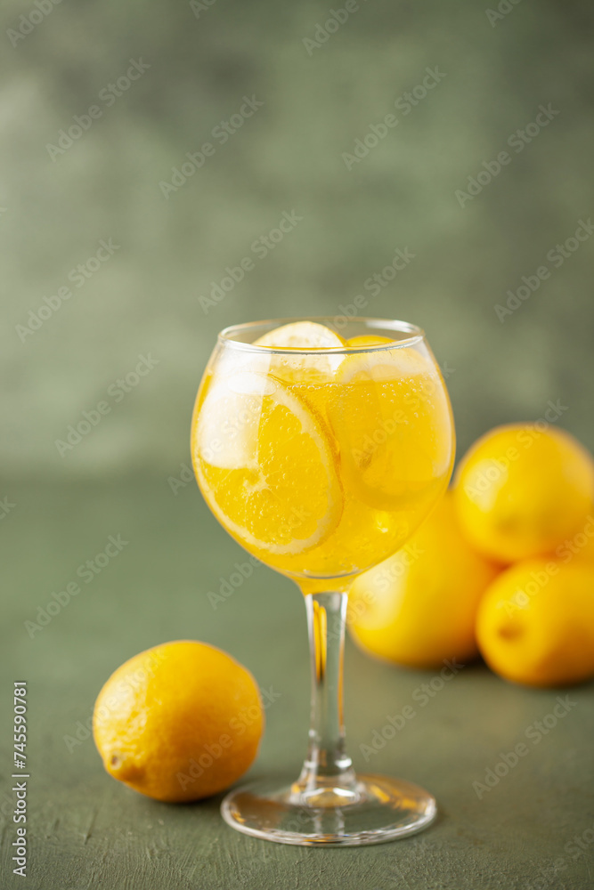 Homemade Limoncello spritz drink of liqueur, sparkling wine and lemon in cocktail glass