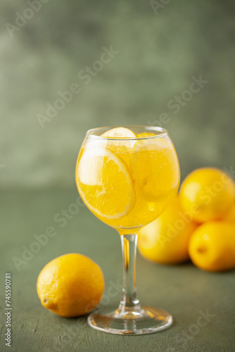 Homemade Limoncello spritz drink of liqueur, sparkling wine and lemon in cocktail glass