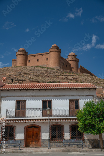 The village La Calahorra, in the province of Granada, Spain with Castillo de La Calahorra on top of hill. It is situated in the Sierra Nevada foothills. photo