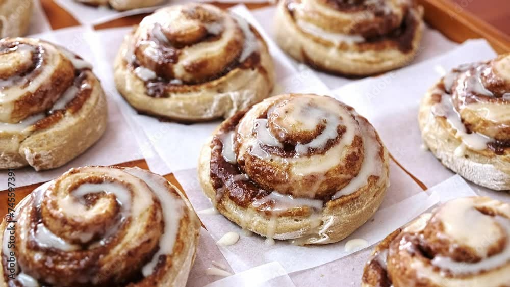 Sugar glazed cinnamon buns on parchment paper Sugar glazed cinnamon buns on parchment paper