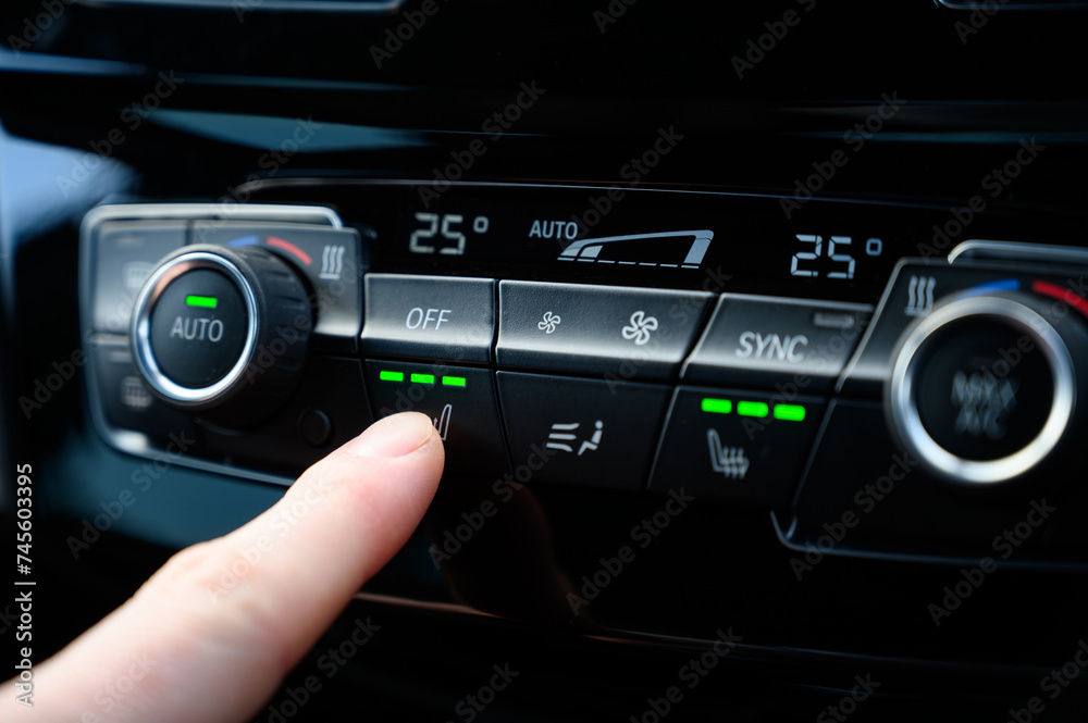 Modern seat warmer controls being pressed Modern seat warmer controls being pressed