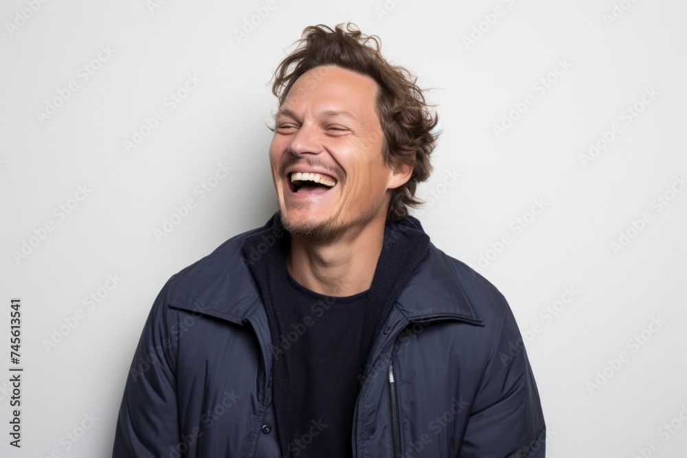 Portrait of a laughing man in a jacket on a white background Portrait of a laughing man in a jacket on a white background